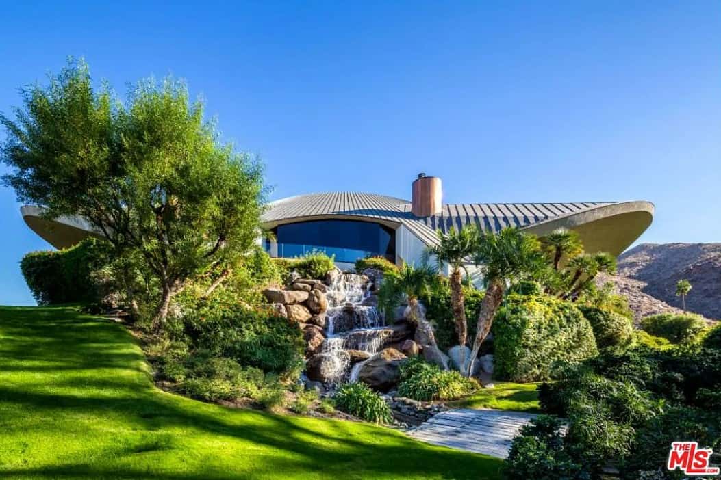 the backyard of Bob Hope's house in Palm Springs with waterfalls and palm trees 