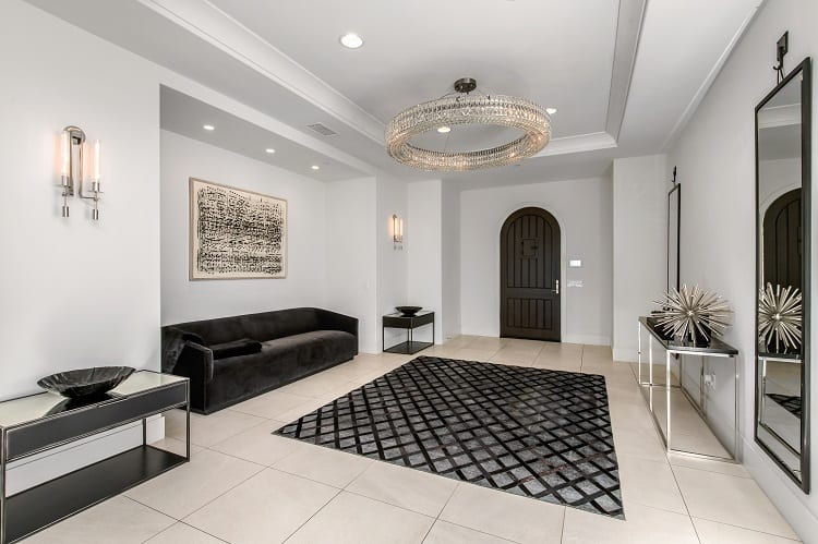 elegant entryway that has an impressive chandelier assortment