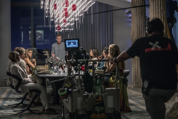 Behind the scenes of Glass Onion: A Knives Out Mystery (2022). (L-R) Janelle Monáe, Daniel Craig, Madelyn Cline, Edward Norton, Kathryn Hahn, and Kate Hudson.