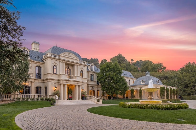 Façade and entrance of the opulent mansion.