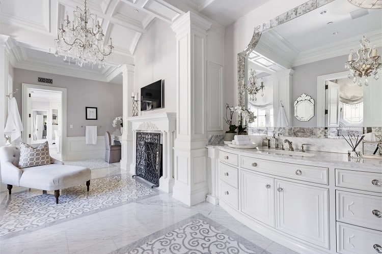 Luxurious bathroom with seating area and fireplace. 