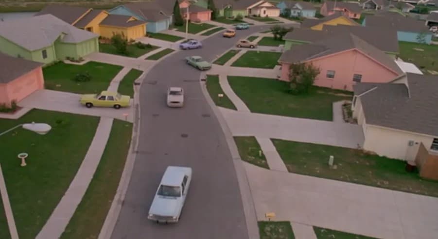 Movie still showing the pastel-colored houses, streets and idyllic town in Edward Scissorhands.