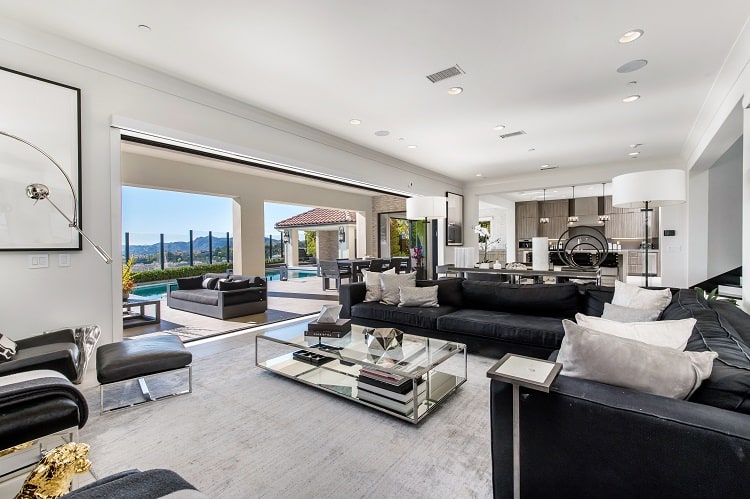 large family room with glass doors opening to the pool area