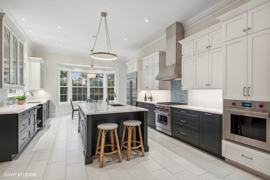 remodeled black and white kitchen with counter seating