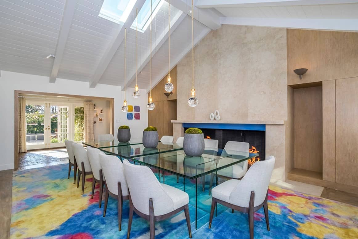 elegant dining room with pendant lighting and a fireplace