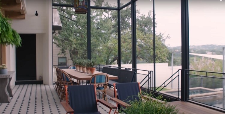 The two-story screened porch featured a custom wood table made out of a 2,000-year-old Cypress log.