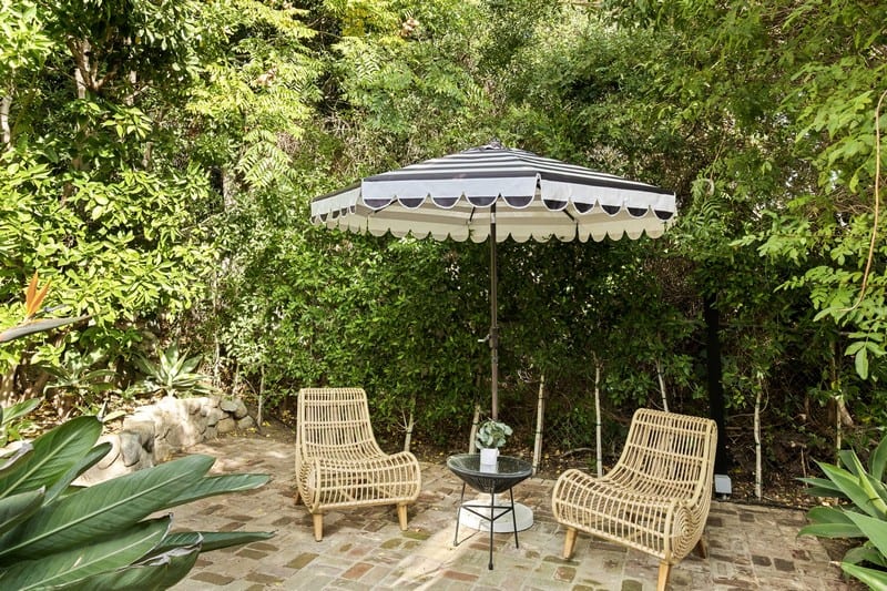 outdoor seating area surrounded by greenery