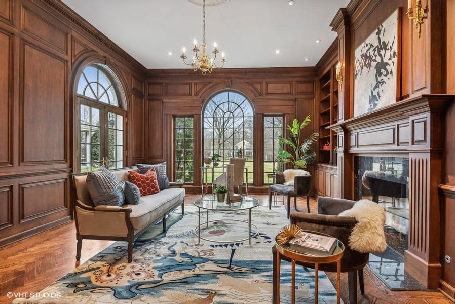 wood paneled library with large windows