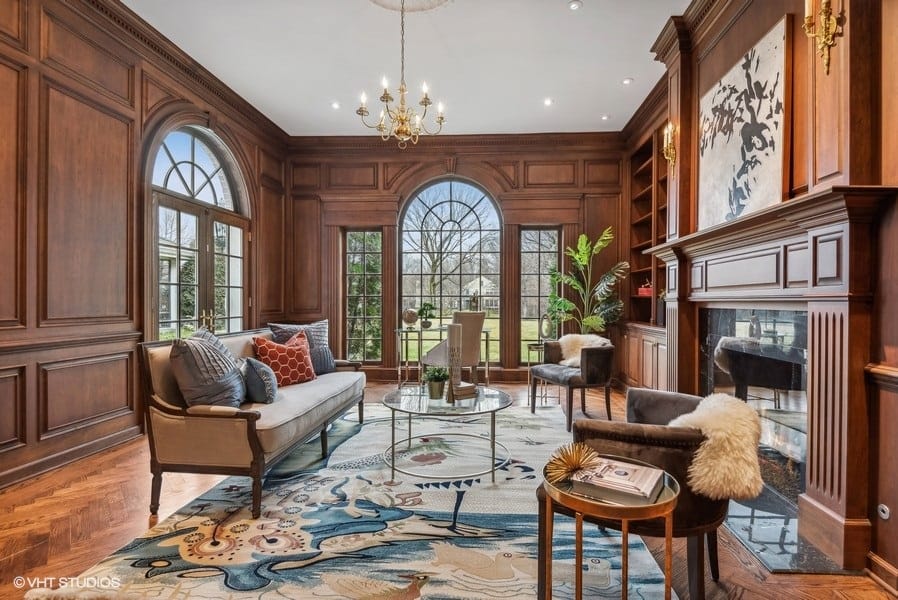 wood paneled library with large windows 