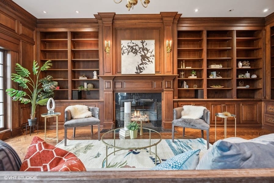 wood paneled library with fireplace