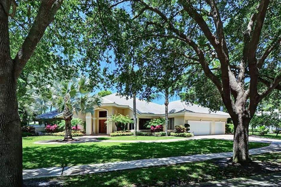 exterior of one of Ariana Grande's childhood homes, a generously sized, one-story house with a palm tree in front