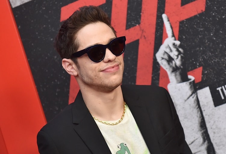 Pete Davidson on the red carpet, wearing sun glasses