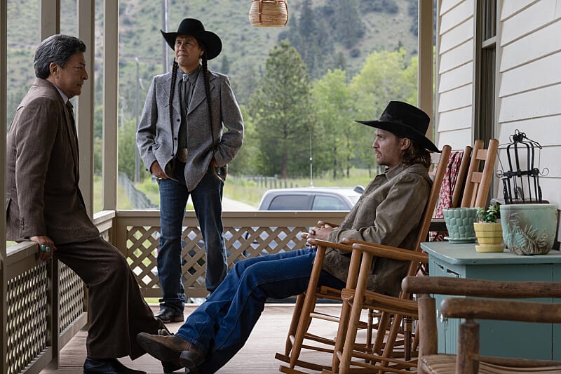 three men sitting on the porch of Yellowstone ranch