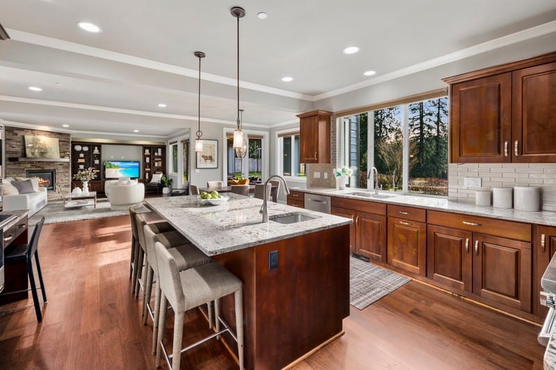 kitchen with marble countertops and dark wood furniture