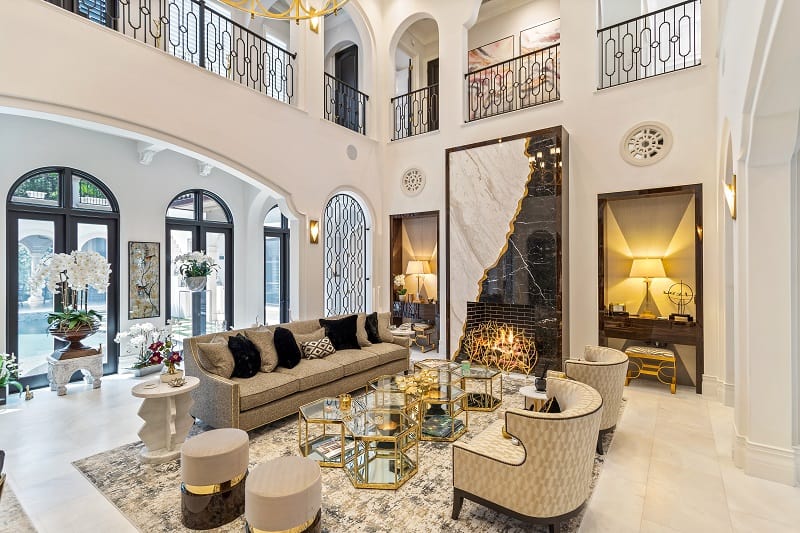 ultra-luxurious living room with arched windows and lots of gold finishes 