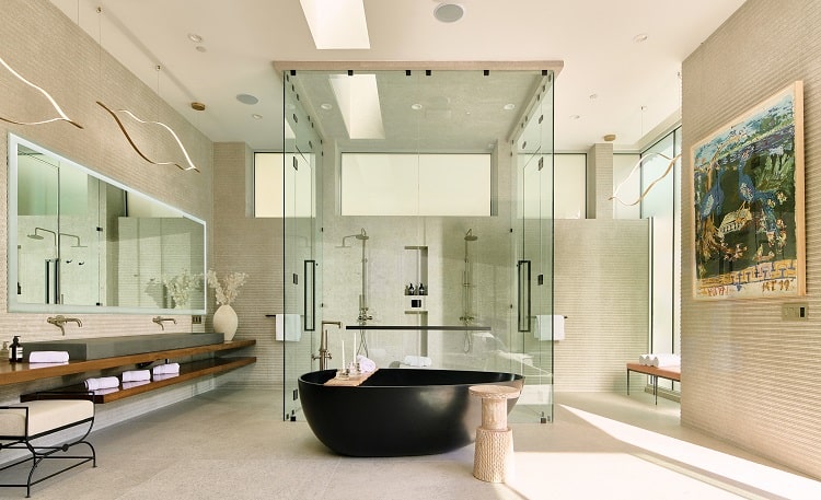 resort-style bath with a floor-to-ceiling glass shower and a separate black soaking tub