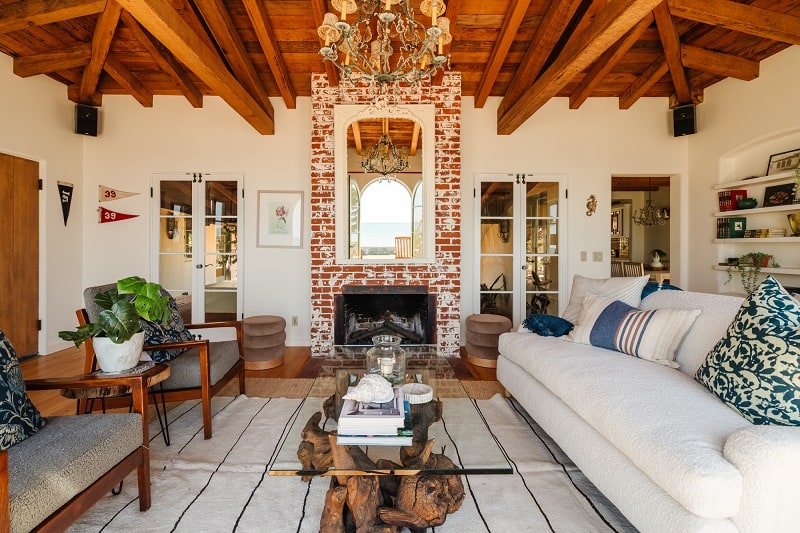 living room with brick fireplace and beamed ceilings