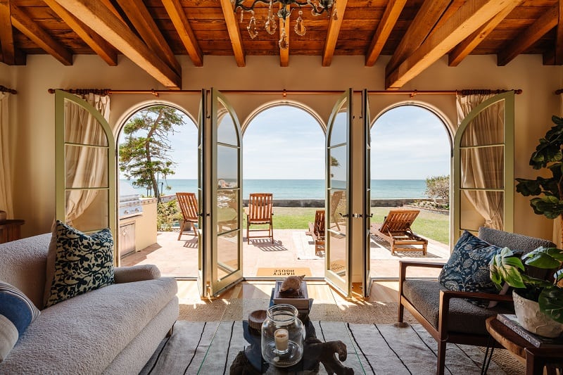 arched doors opening up to the lawn, with the ocean in the background