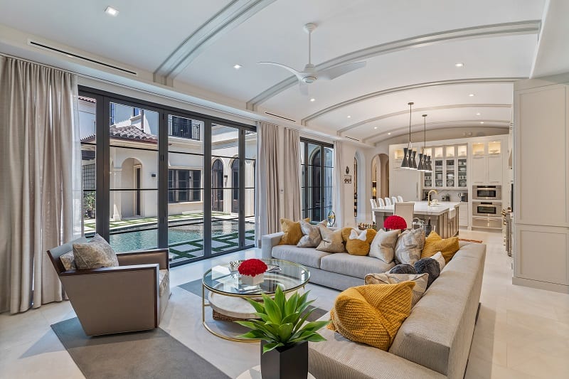 living area with a large sectional couch and the kitchen visible behind it