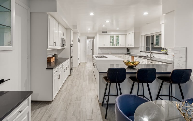 white kitchen with velvet bar stools