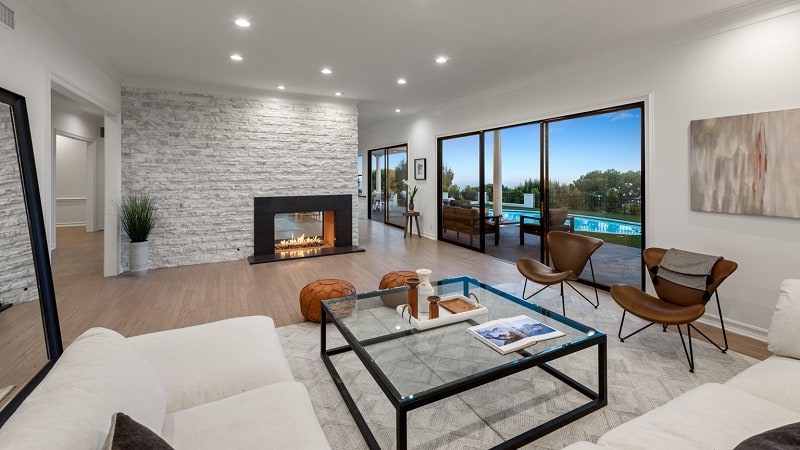 living room with sliding glass doors and a lit fireplace