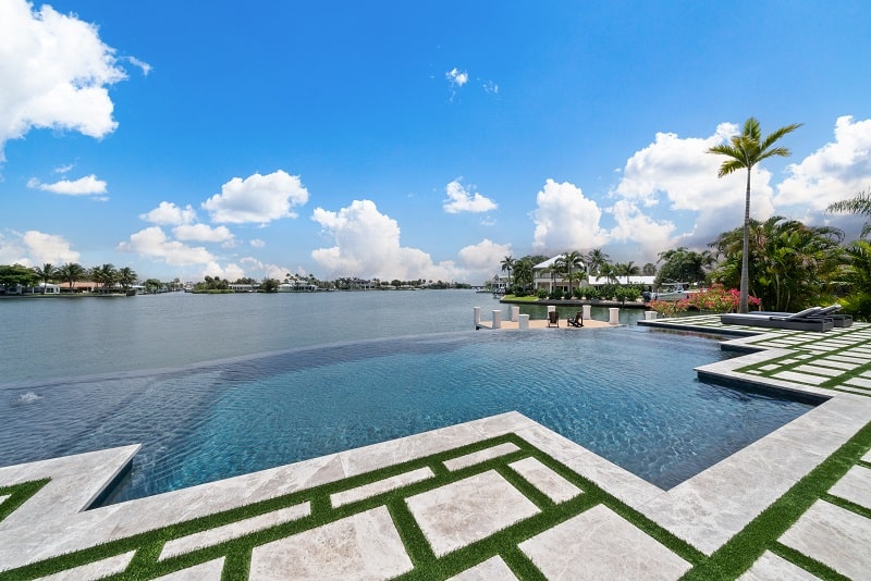 infinity pool that seems like its pouring into the lake