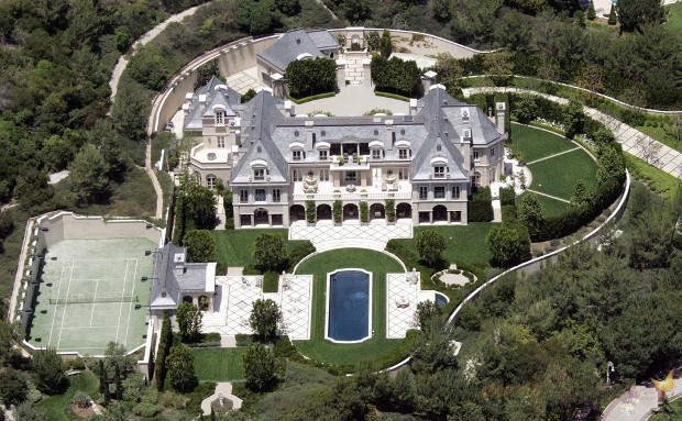 Aerial view of Denzel Washington's house, a 28,887-square-foot mega-mansion in the upscale Beverly Park enclave, with a tennis court, pool, and lush greenery