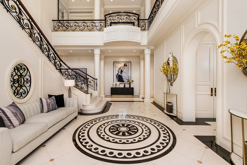 hallway and staircase with white and black accents inside Paris Hilton's new house