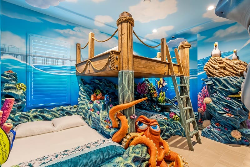 nautical-themed kids bedroom with a suspended bed and characters from Finding Nemo
