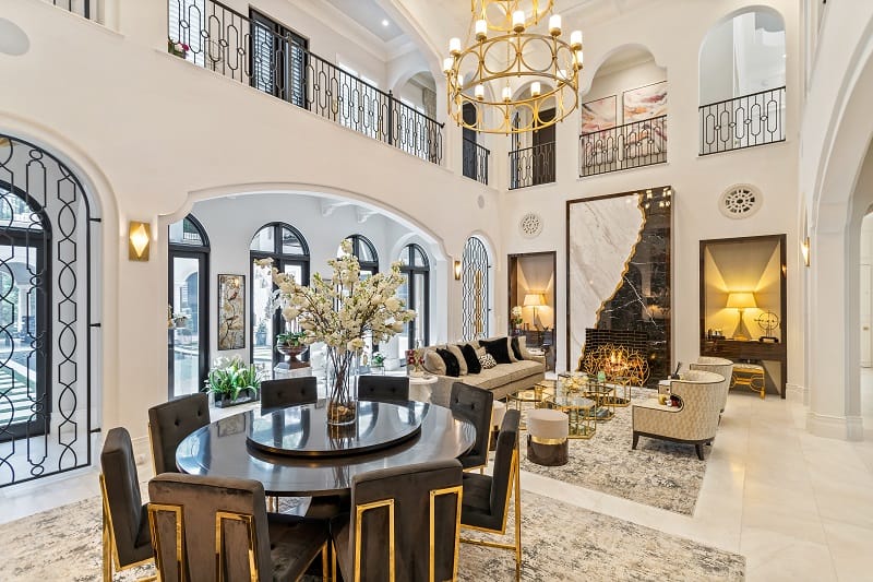 ultra-luxurious living room with arched windows and lots of gold finishes 