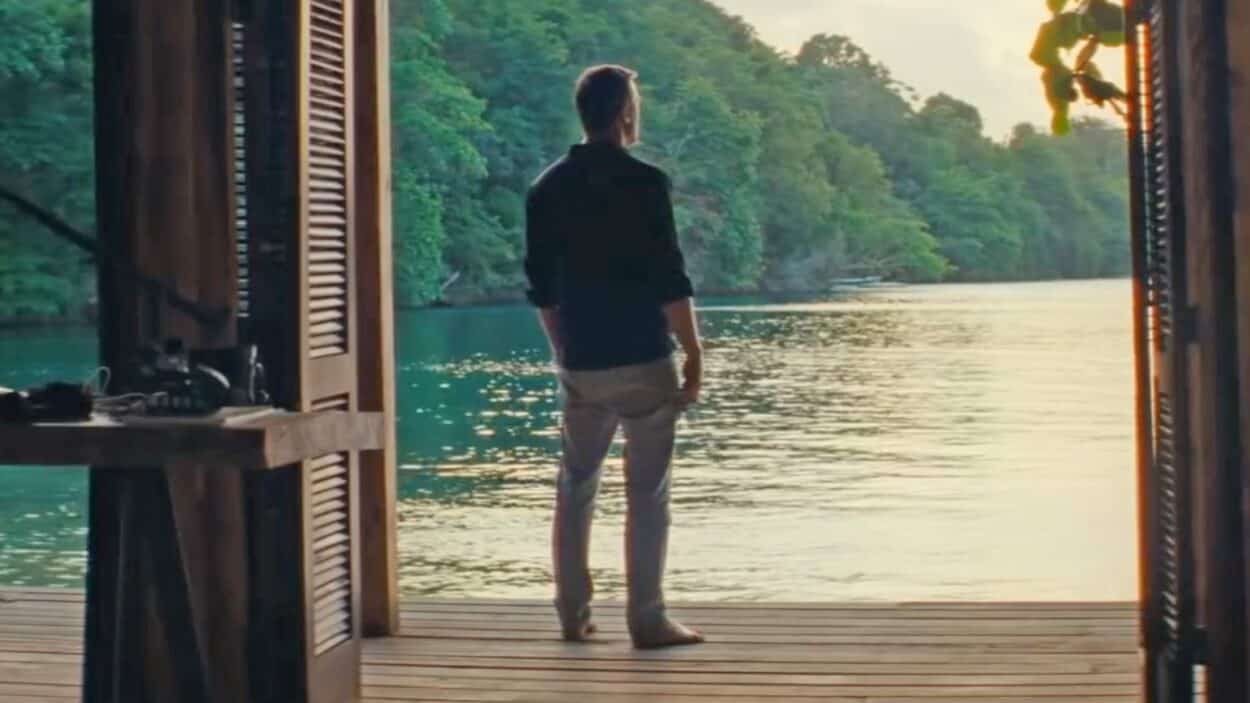 Daniel Craig as James Bond looking out into the water from his house in Jamaica in No Time To Die (2021)