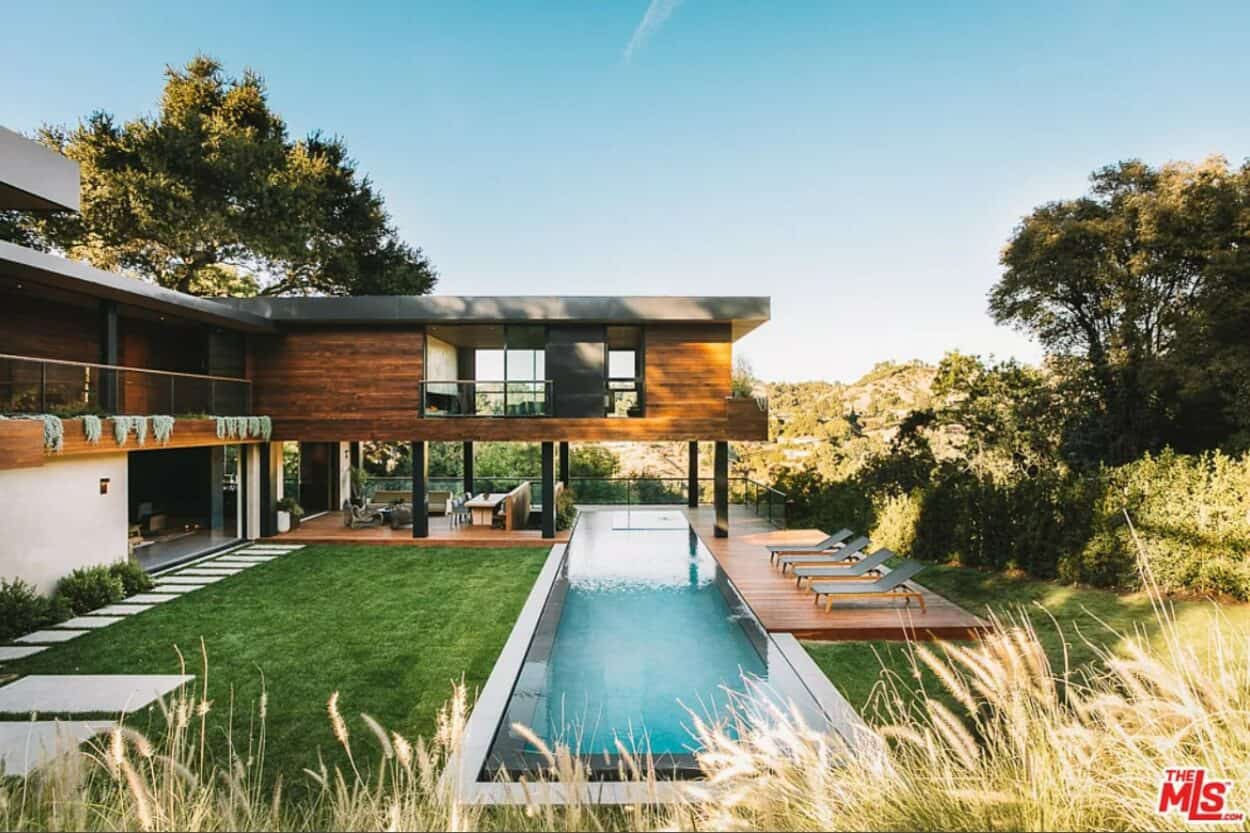 Lizzo's house in LA, a treehouse-style luxury villa perched on stilts above the rectangular pool