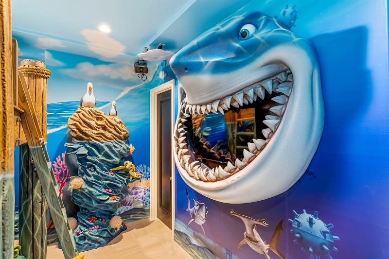 wall of a Finding Nemo-themed kids bedroom with a shark seemingly coming out of a dark blue wall