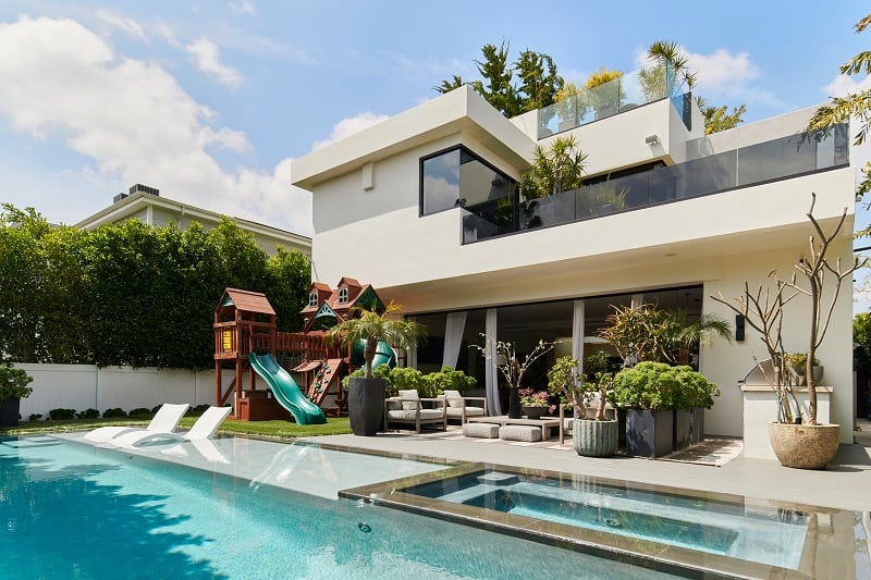 modern house backyard with pool and play structure