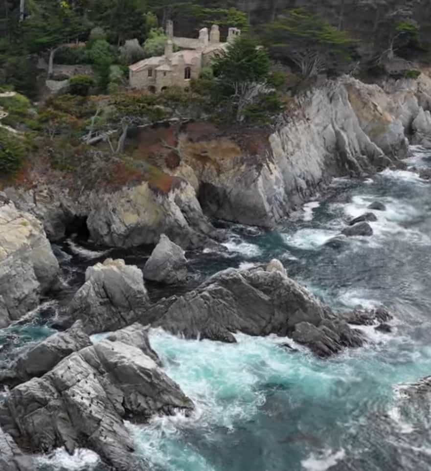 The D.L. James Seaward house looming over the ocean. 