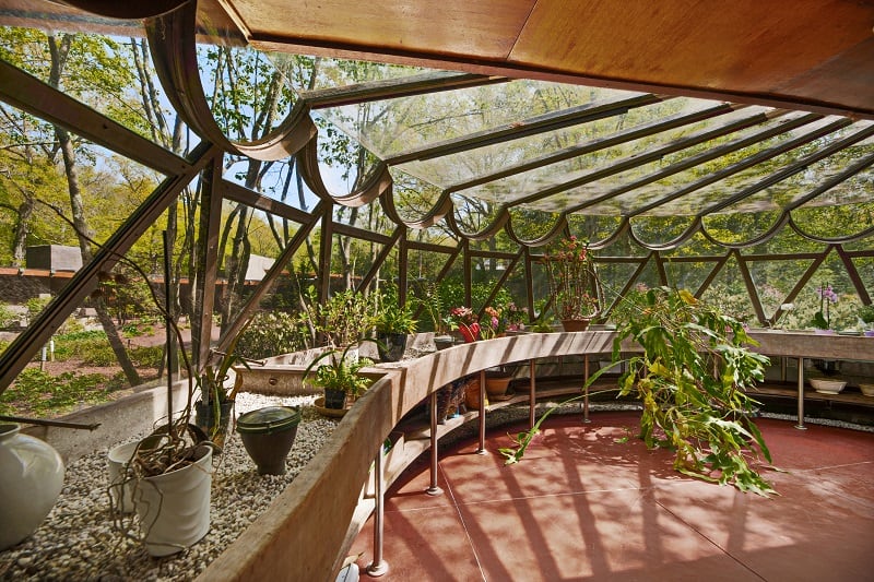 conservatory room covered with glass, wood and steel