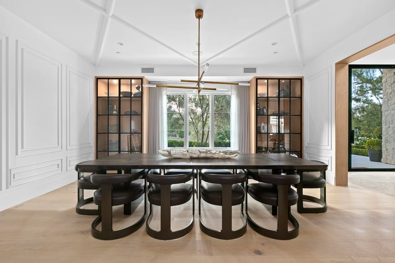 elegant dining room with dark furniture and leather seating