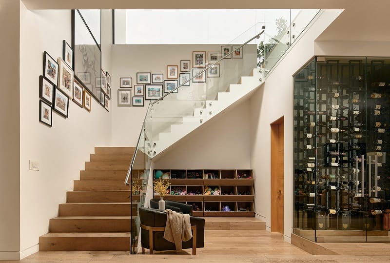 floating staircase next to a wine chiller 