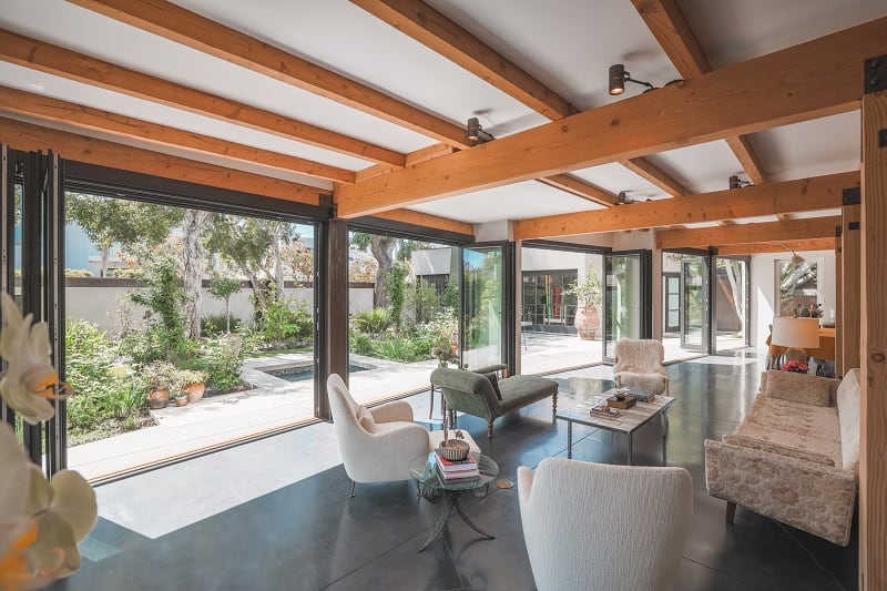 indoor-outdoor partition in a living room with warm wooden beams 