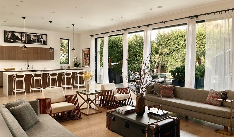 living room and kitchen with large sliding doors that open to outdoor area