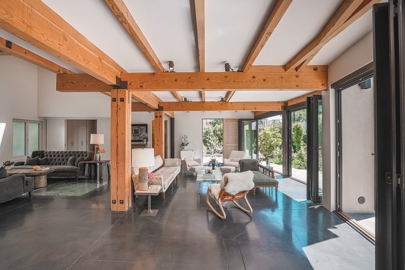 living room area with relaxation nook and large wooden beams on the ceiling