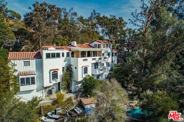 exterior of Marilyn Monroe and Joe DiMaggio's house, a large 4-bedroom, three-story house with white exteriors and shingled roof