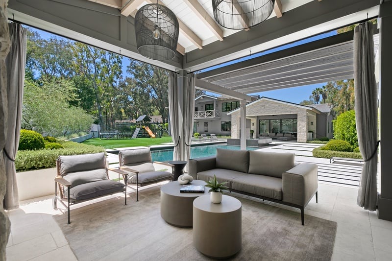 outdoor lounging area next to the pool