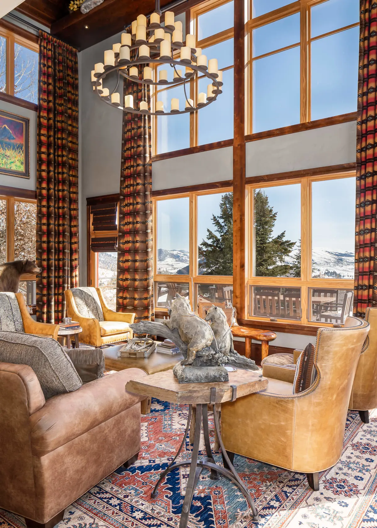 ranch living room with two-story windows and a chandelier above a sitting area