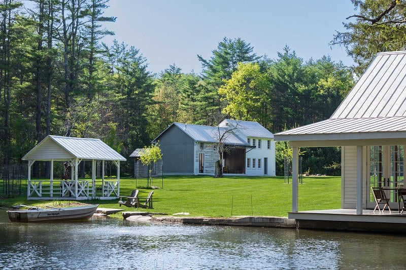 The barn seen from the water, along with the other structures on the property