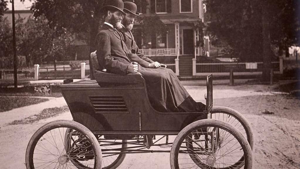 A black and white photo of Freelan Oscar Stanley and his twin brother, Francis Edgar Stanley in one of their steam cars (circa 1898). 