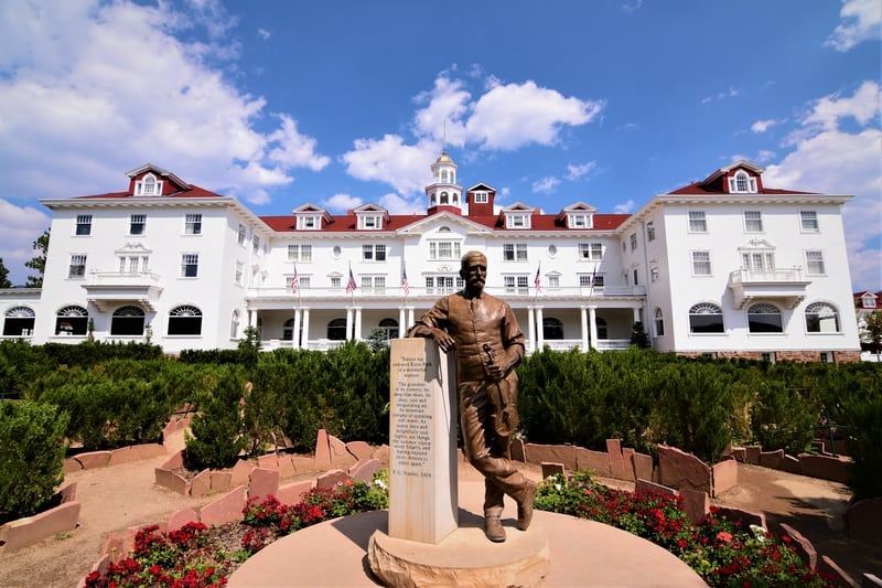 A statue of Mr. Stanley in front of the hedge maze at the Stanley Hotel in Estes Park Colorado.