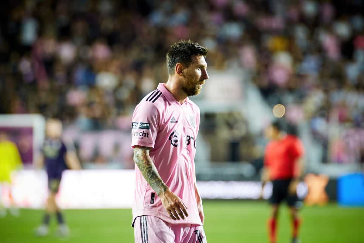 Lionel Messi on the soccer field playing for Inter Miami in August 2023 and wearing the team's pink jersey