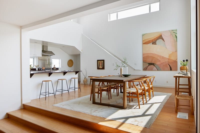 The clerestory windows in Yellowstone actress Jen Landon’s house, set above the stairs, with a colorful painting underneath