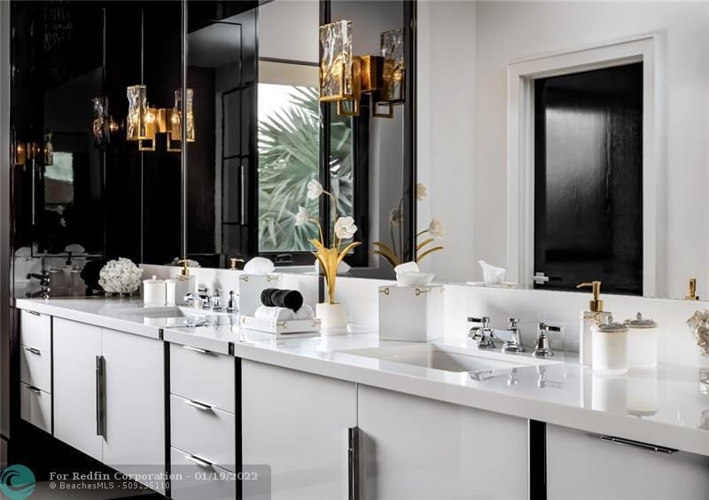 Black and white bathroom with gold fixtures inside Lionel Messi's house in Fort Lauderdale, Florida